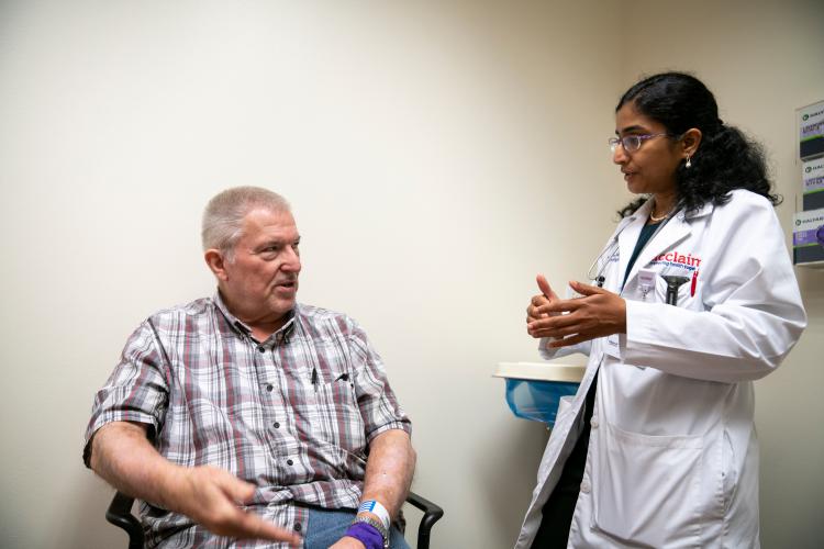 Dr. Kalyani Narra, an oncologist at JPS Health Network, talks with a patient at the JPS Center for Oncology and Infusion in Fort Worth, Texas