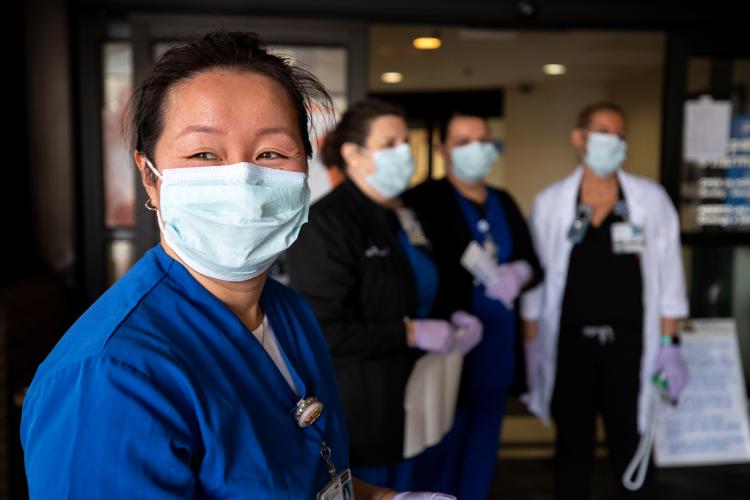 JPS Health Network Nurses wear their masks as the await patients at a COVID screening checkpoint