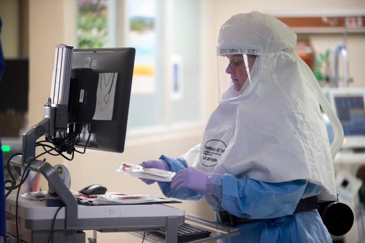 A JPS Health Network respiratory therapist monitors a COVID-19 patient.