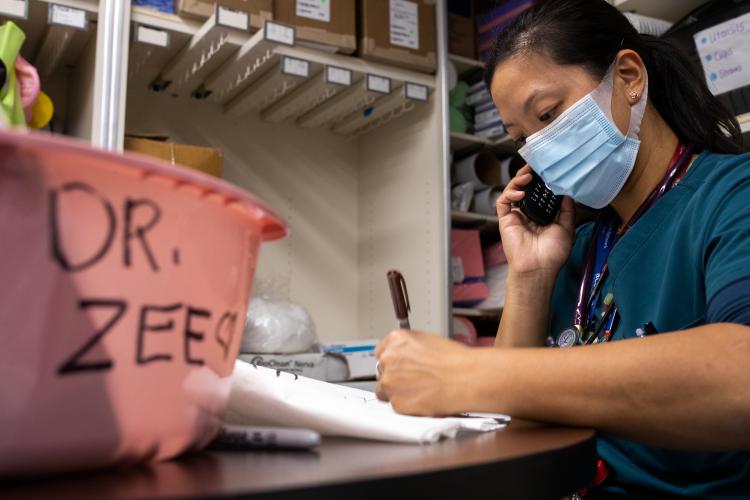 Dr. Jocelyn Zee, 2000 Acclaim Physician Group Physician of the Year, works in the personal protective equipment dressing area at JPS Health Network.