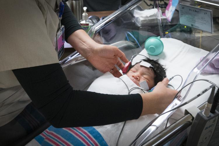 Infant receiving hearing test