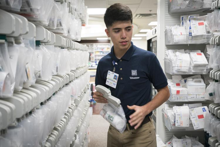 JPS Junior Volunteer Sergio Alonzo Works in the Pharmacy.