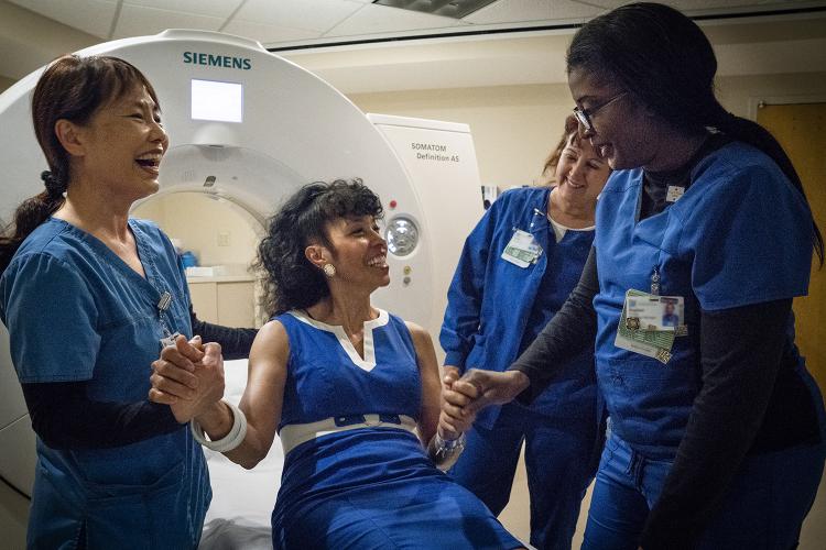 RN Minsuh Bae, from left, chats with former JPS patient Teryl Dorham, RN Team Sylvia Baker and RN Clinical Manager Daphne Young before a radiology appointment.