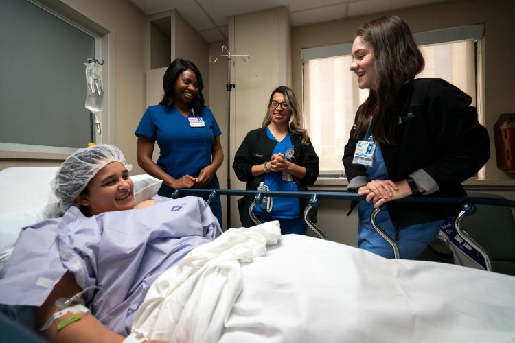 Tania Ayala, second from right, talks to a patient at JPS Health Network in Fort Worth, Texas.