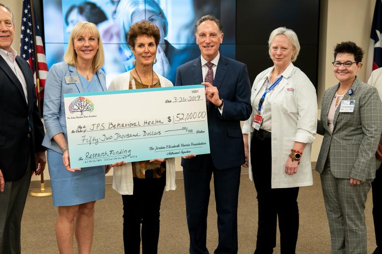 Representatives of the Jordan Elizabeth Harris Foundation deliver a donation for suicide prevention research to JPS Health Network on Tuesday, March 26, 2019 in Fort Worth, Texas.