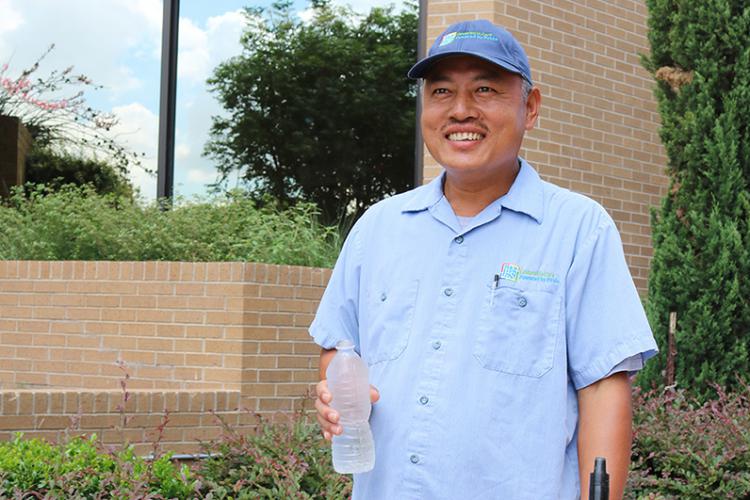 JPS Housekeeper Bali Gurung takes time from his work for a drink of water