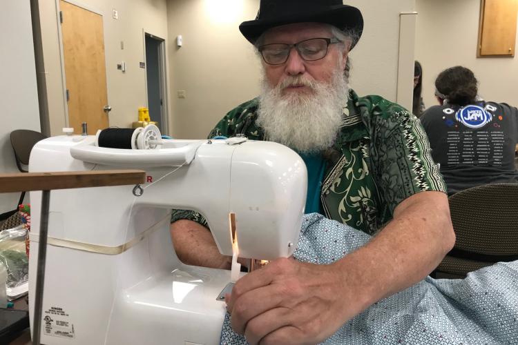 JPS volunteer sewing a quilt