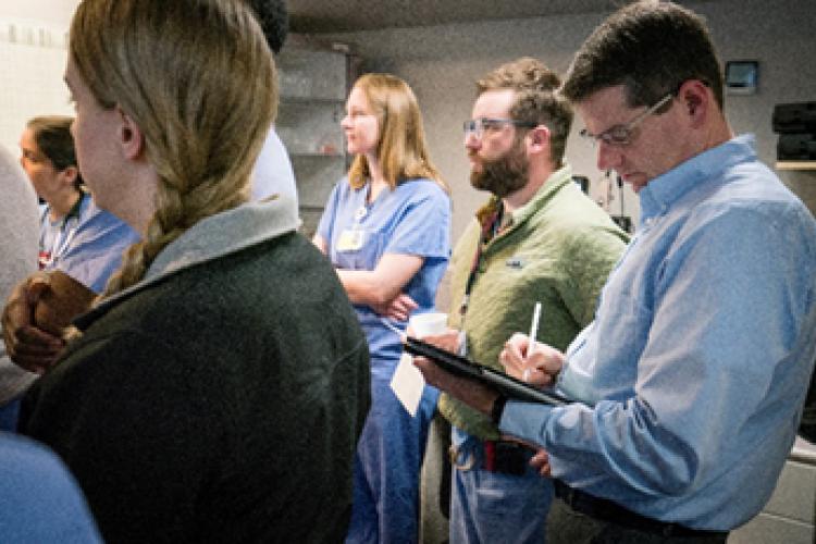 Clinical Library Manager Tim Kenny, with attending physicians and residents during morning hand-off in OB/GYN