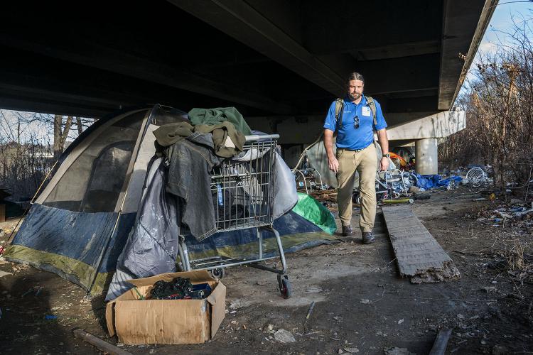 Joel Hunt, Director of Care Connections Outreach at JPS Health Network, looks for people living beneath an overpass
