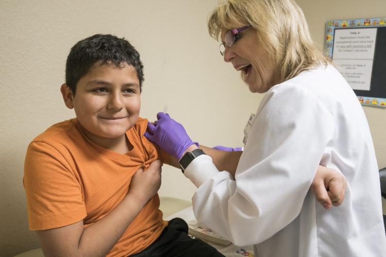 Child receiving a shot at JPS