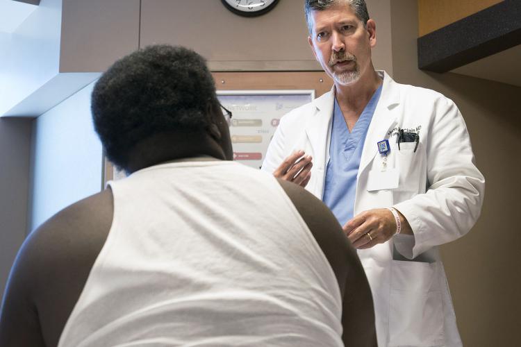 Sound physician Dr. John McClain talks with a patient