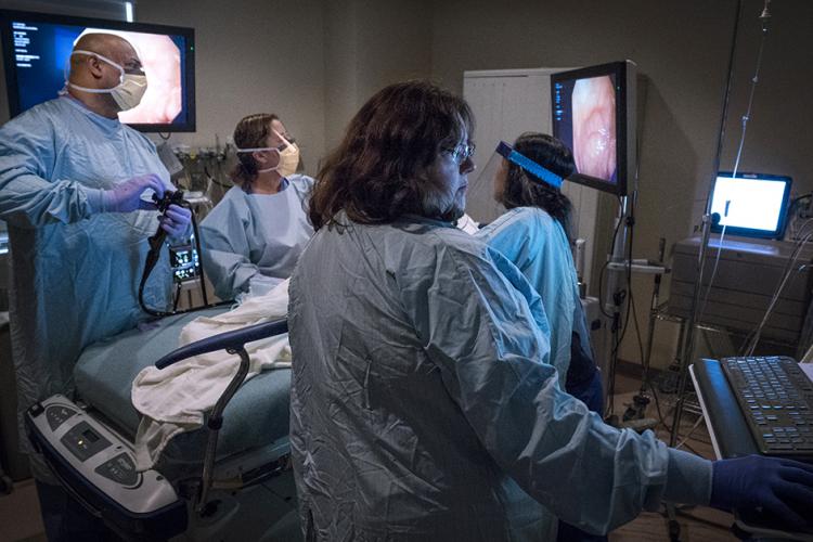 Dr. Rajesh Gandhi, left, leads a surgical team in a JPS operating room