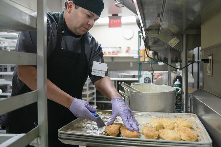 JPS Health Network Nutritional Services Cook II Jose Romero prepares lunch