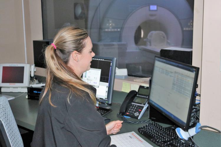 MRI Technician Amber Adam gets ready to scan a patient