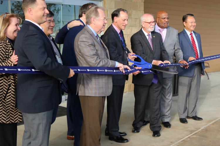 JPS Health Network President and CEO Robert Earley cuts the ribbon to officially dedicate the JPS Medical Home Northeast Tarrant