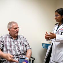 Dr. Kalyani Narra, an oncologist at JPS Health Network, talks with a patient at the JPS Center for Oncology and Infusion in Fort Worth, Texas