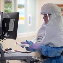 A JPS Health Network respiratory therapist monitors a COVID-19 patient.