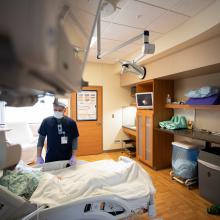 A JPS Health Network team member talks with a patient in their room.