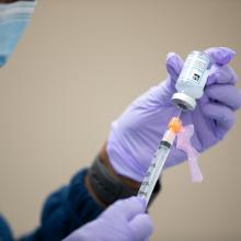 A nurse at JPS Health Network prepares to give a COVID-19 vaccination.