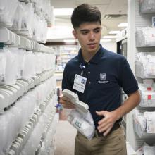 JPS Junior Volunteer Sergio Alonzo Works in the Pharmacy.