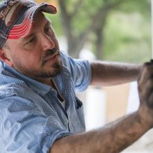 Jimmy Jenkins works on a mural at the Fort Worth Zoo