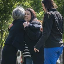 Emily Avila, center, receives a hug from Lee Ann Franklin