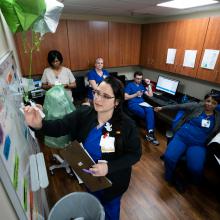 Nurses gather as they get ready to do a shift change hand-off at JPS Health Network in Fort Worth, Texas