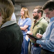 Clinical Library Manager Tim Kenny, with attending physicians and residents during morning hand-off in OB/GYN