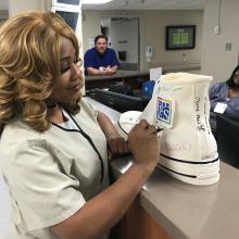 Multi-Skilled Tech Sherica Owens signs the Walk the Walk Shoe