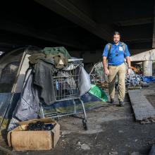 Joel Hunt, Director of Care Connections Outreach at JPS Health  Network, looks for people living beneath an overpass