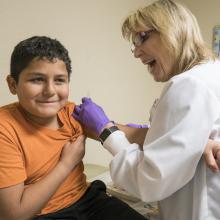 Child receiving a shot at JPS