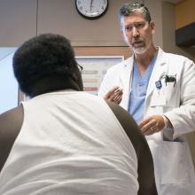 Sound physician Dr. John McClain talks with a patient