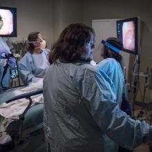 Dr. Rajesh Gandhi, left, leads a surgical team in a JPS operating room