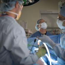 David Olson, CRNA, watches over a patient in an operating room at JPS