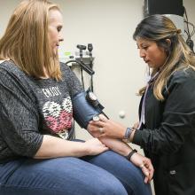 Klabzuba Clinic patient Valerie O'Brien, from left, has her blood pressure checked by CMA Denise Moreno