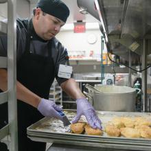 JPS Health Network Nutritional Services Cook II Jose Romero prepares lunch