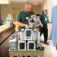 Clinical Engineering team members place infusion pumps