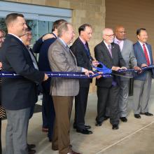 JPS Health Network President and CEO Robert Earley cuts the ribbon to officially dedicate the JPS Medical Home Northeast Tarrant