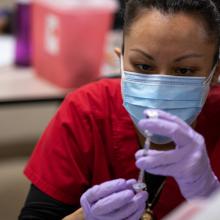 A COVID vaccination is given at JPS Health Network in Fort Worth, Texas